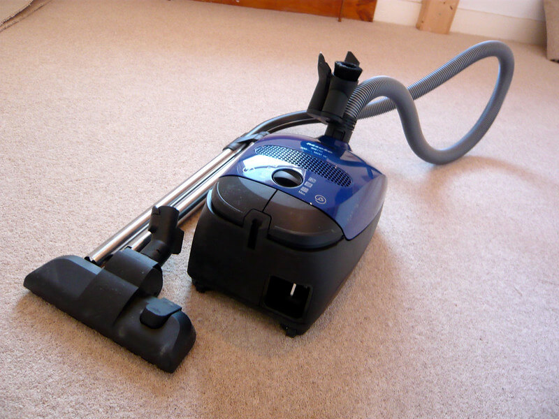 Vacuuming Carpet for the First Time to Remove Debris and Odor